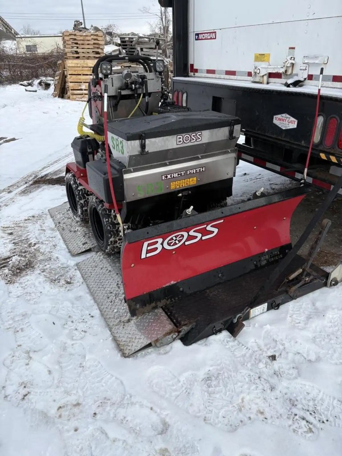 Snow plow clearing a commercial parking lot in Metro Detroit