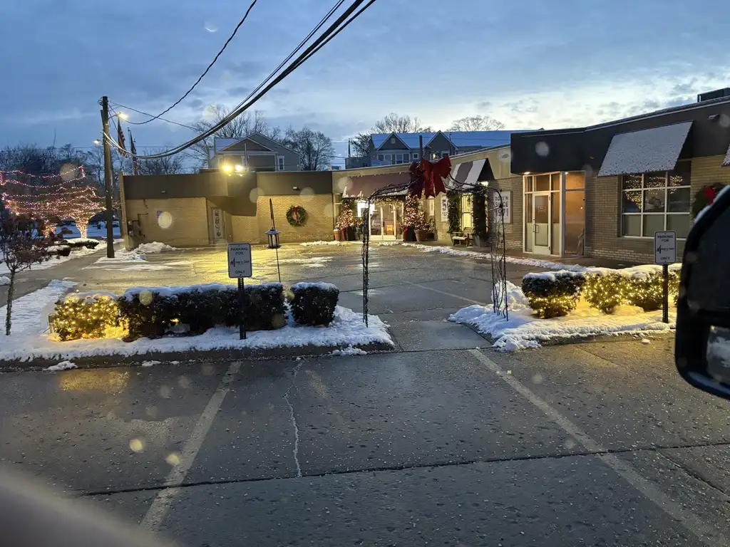 Commercial landscape lighting illuminating walkway and entrance at dusk