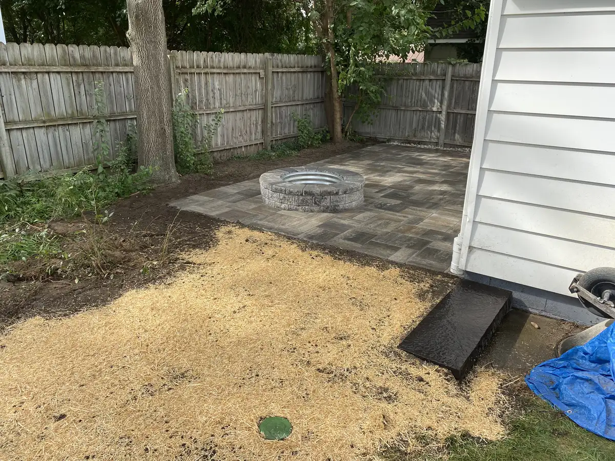 Natural stone fire pit on flagstone patio with garden setting