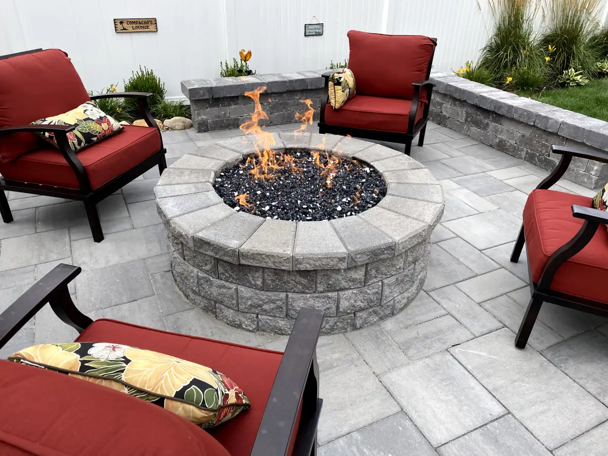 Luxury fire pit patio with lounge seating by The Guy Outdoor Services in Metro Detroit