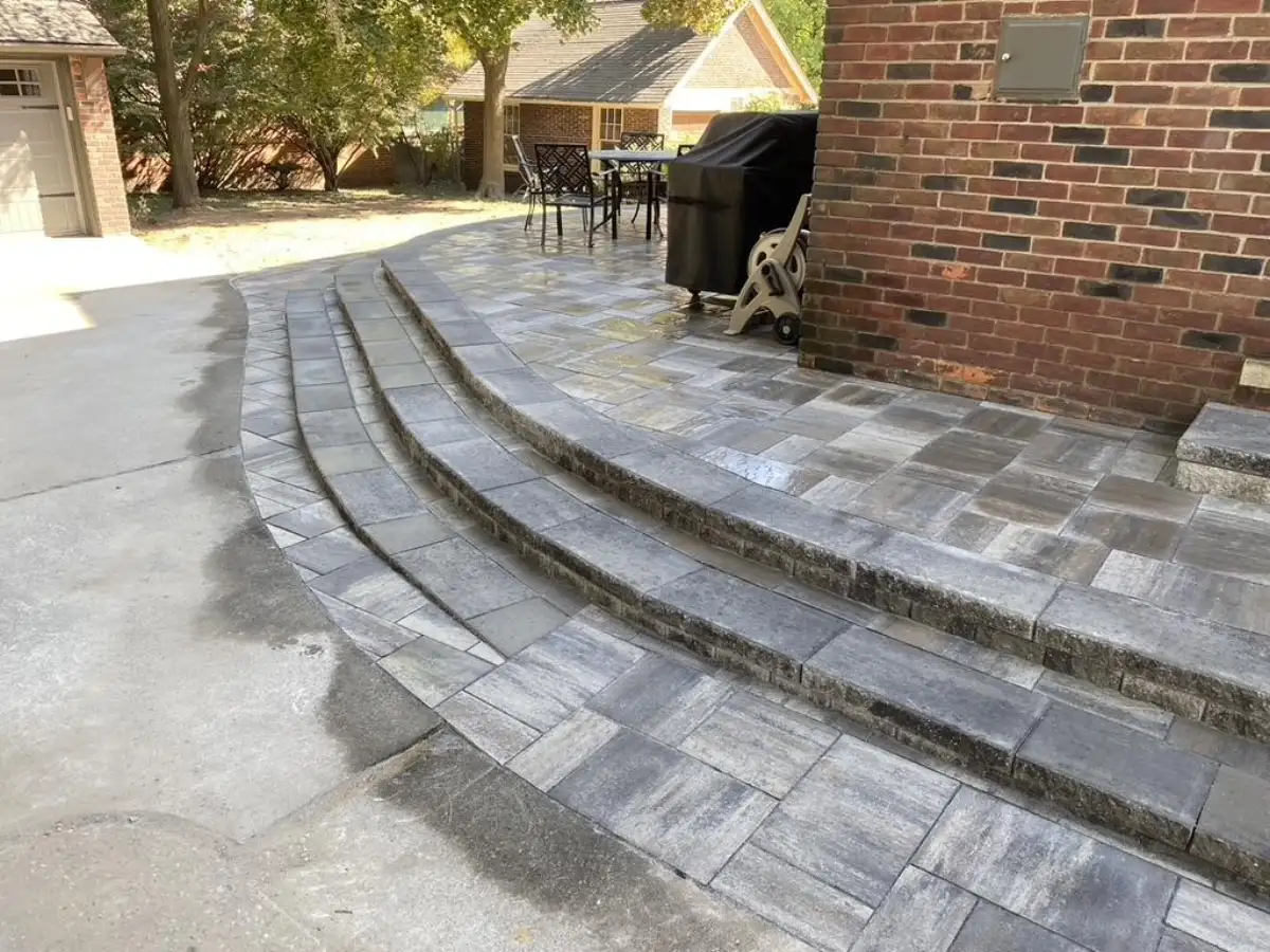 Elevated paver patio with curved retaining wall steps