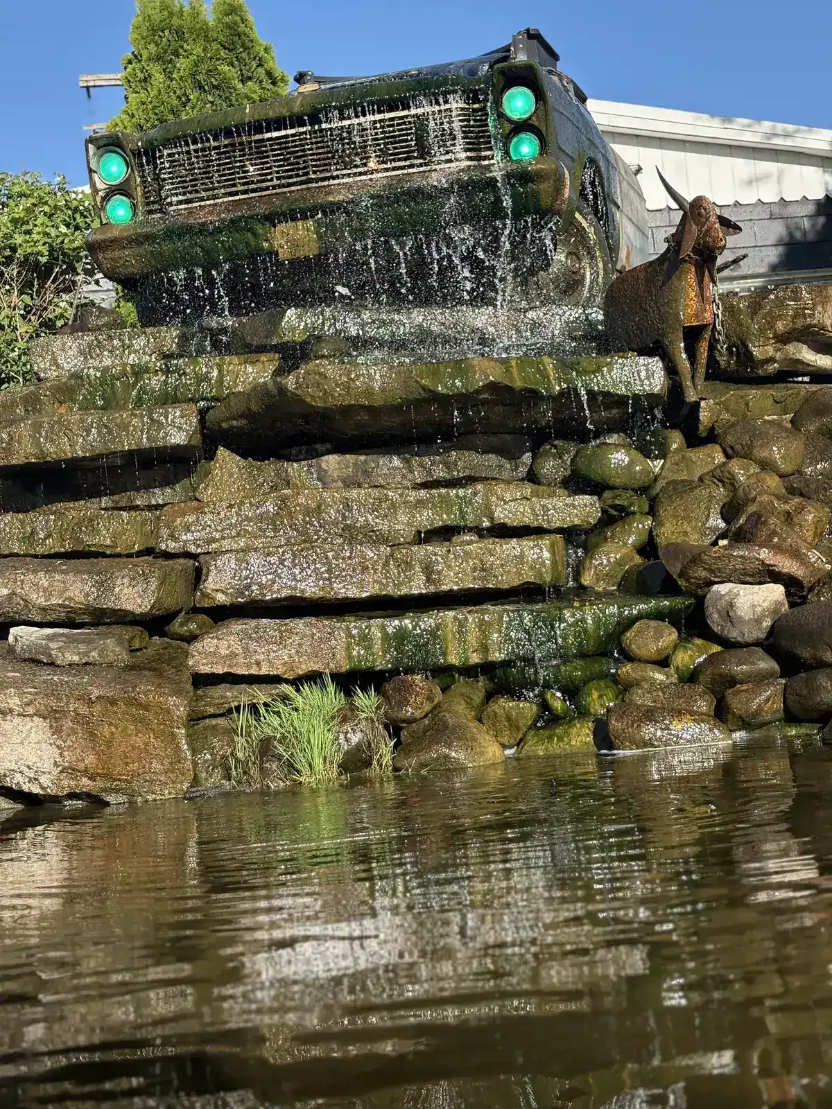 The Guy Outdoor Services signature vintage truck waterfall feature — a Metro Detroit landmark