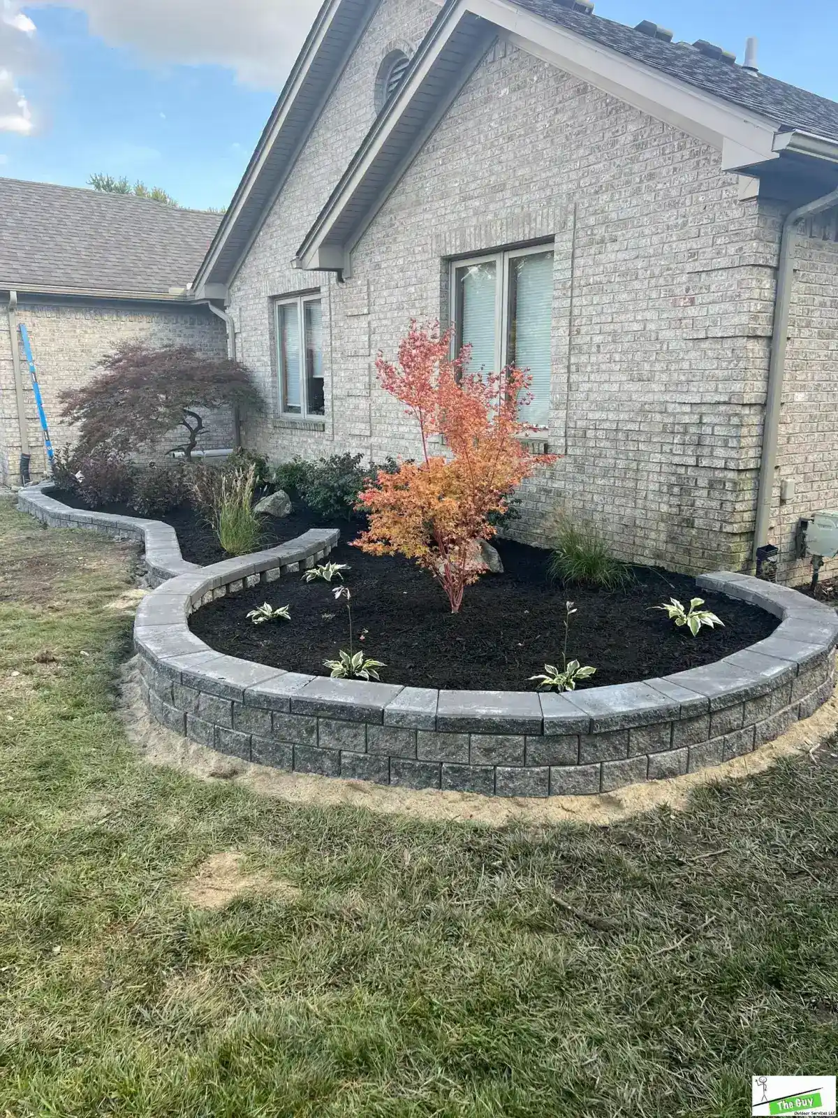 Curved retaining wall with Japanese maple and raised planting bed design