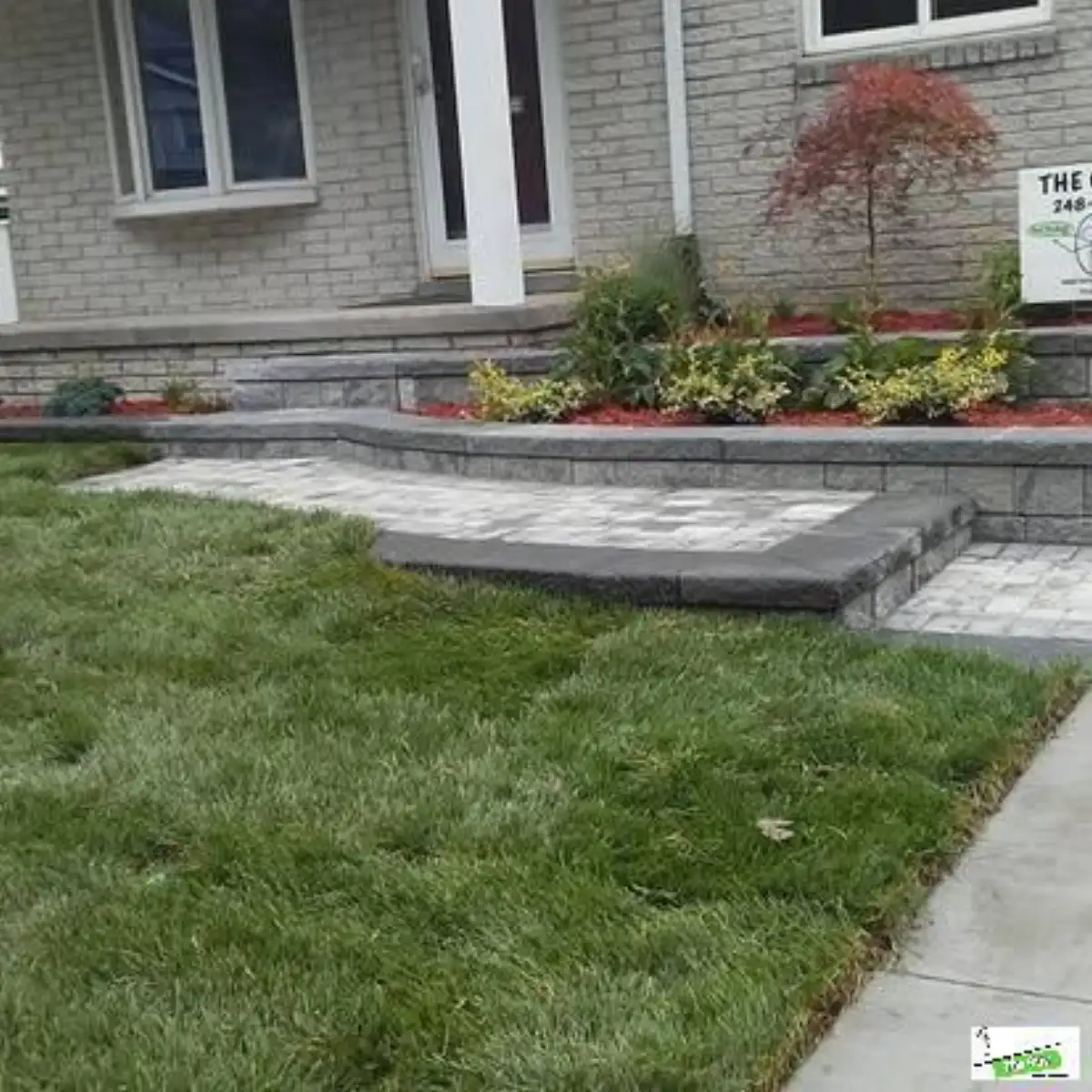 Craftsman home with decorative dual-tone gravel bed and shrub plantings