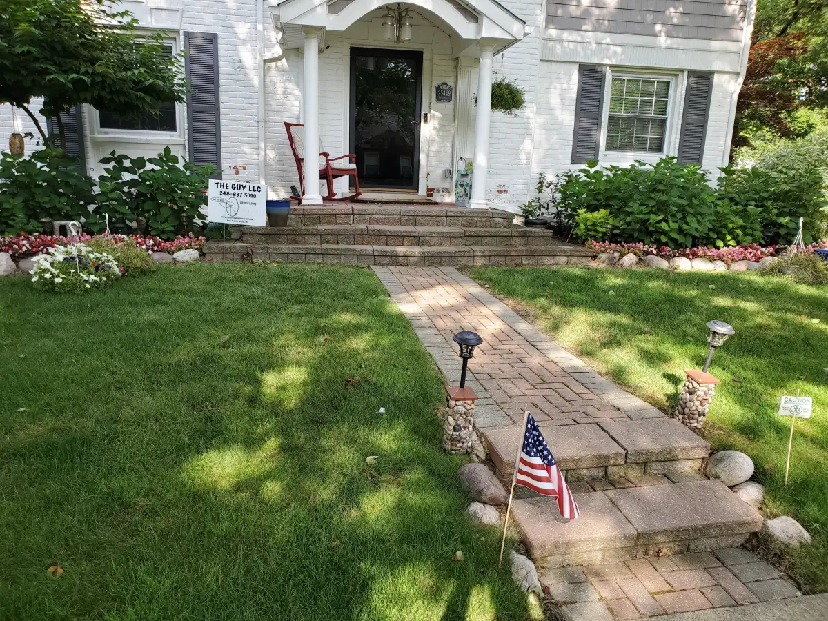 Paver walkway with installed path-light fixtures by The Guy Outdoor Services