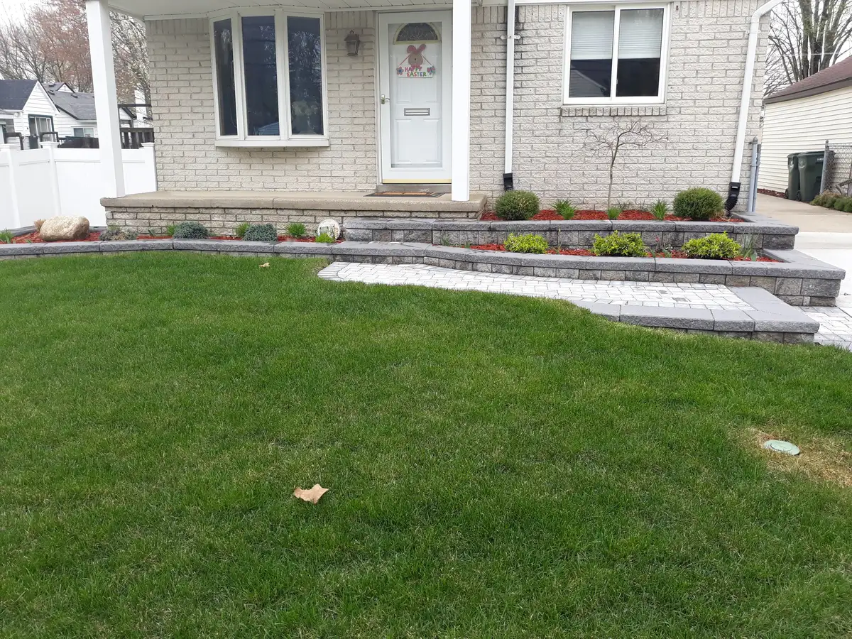Fresh landscape bed with lawn edge and Michigan-hardy plantings