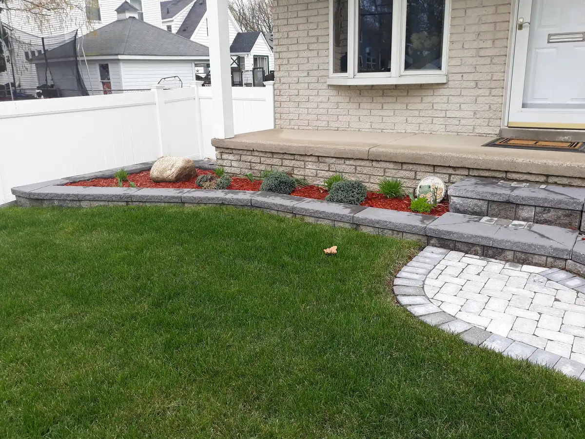 Fresh sod and lawn repair near a residential walkway