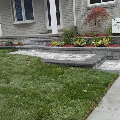 Landscape bed designed around drainage and low-maintenance planting