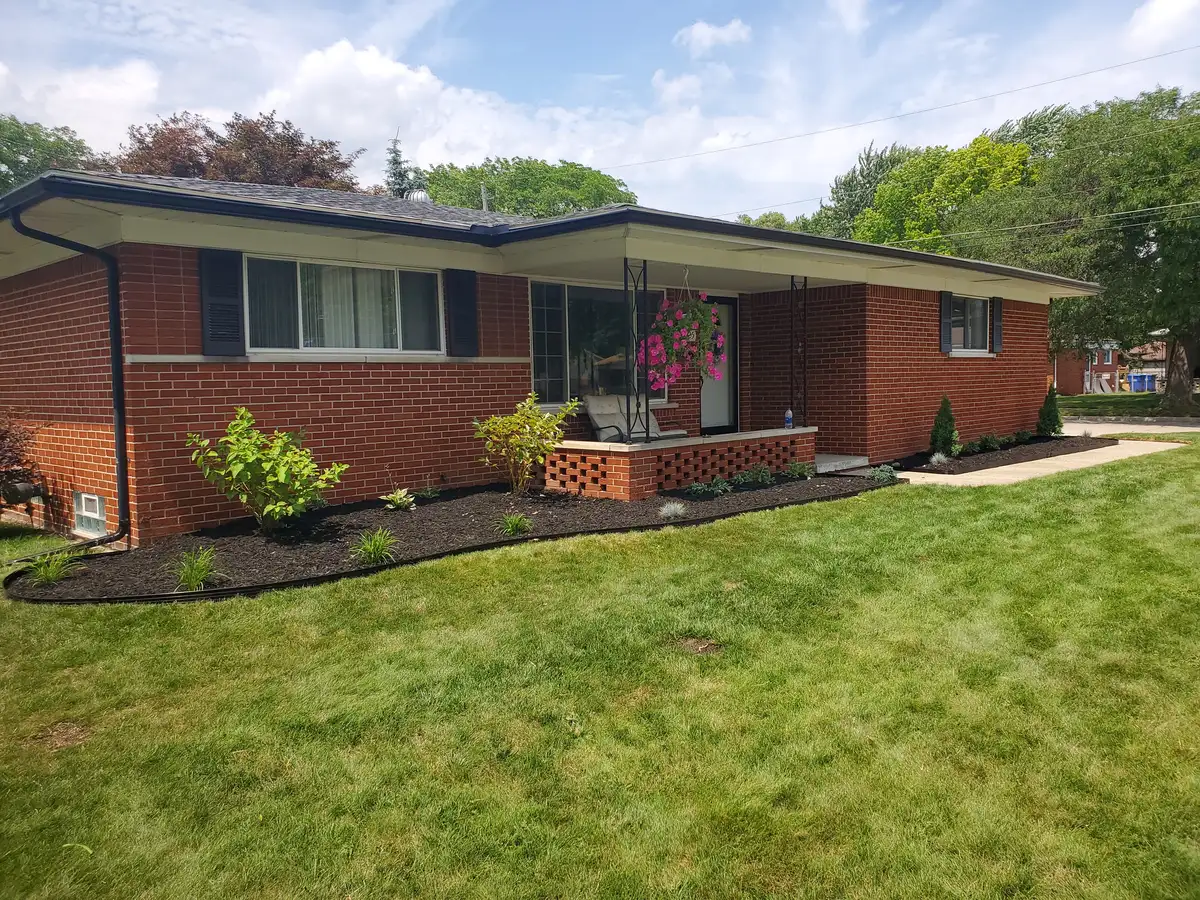 Finished front yard with lawn and dark-mulched foundation planting beds