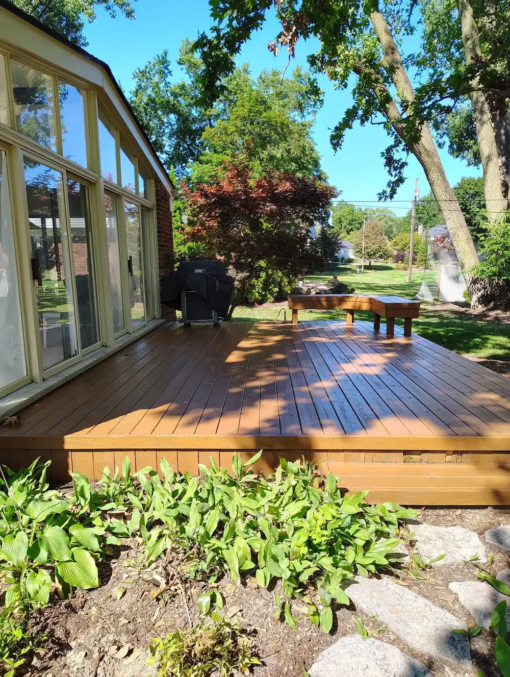 Deck with built-in grill area and Japanese maple landscaping