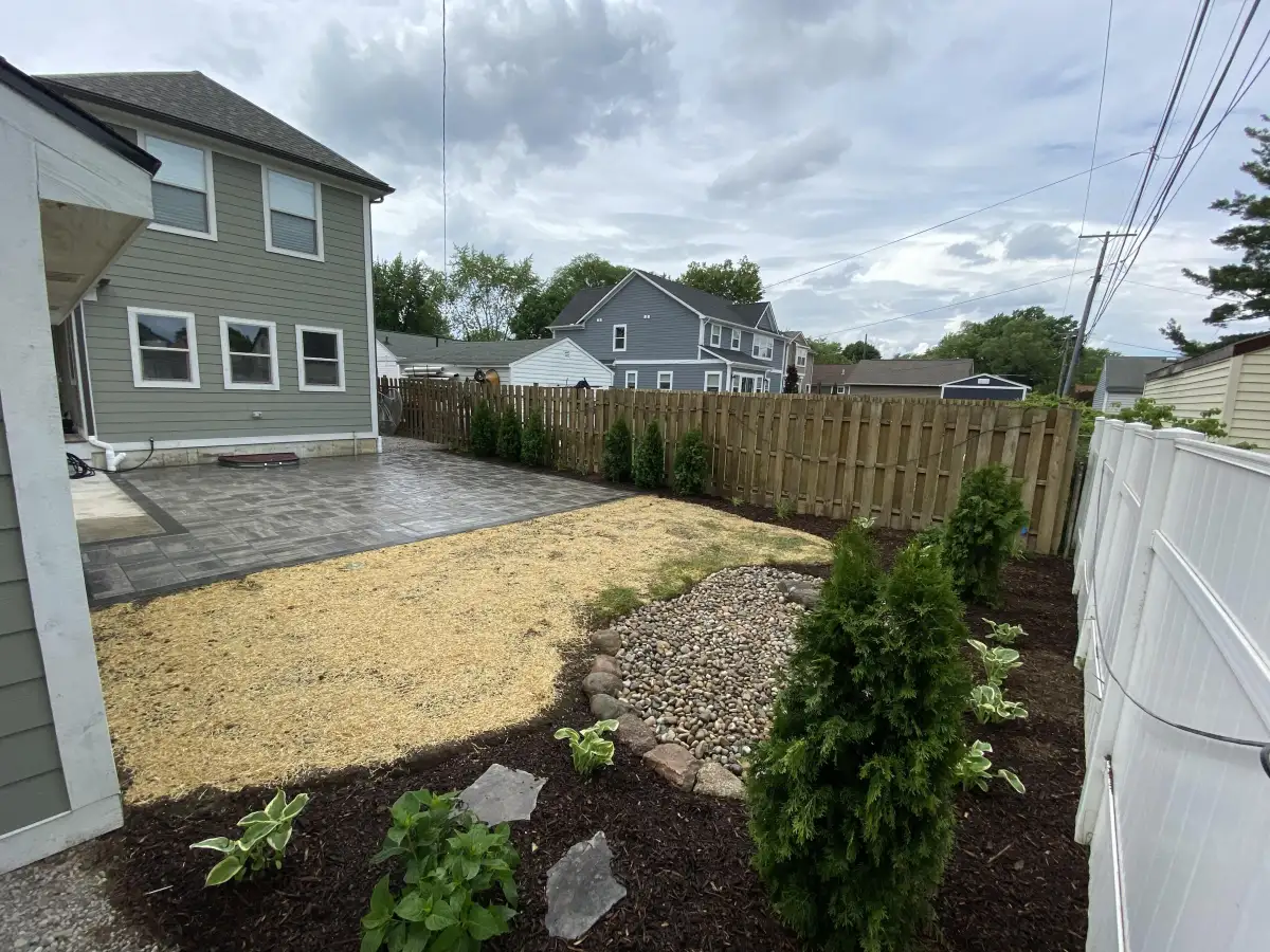 Completed brick paver patio and landscape design by The Guy Outdoor Services