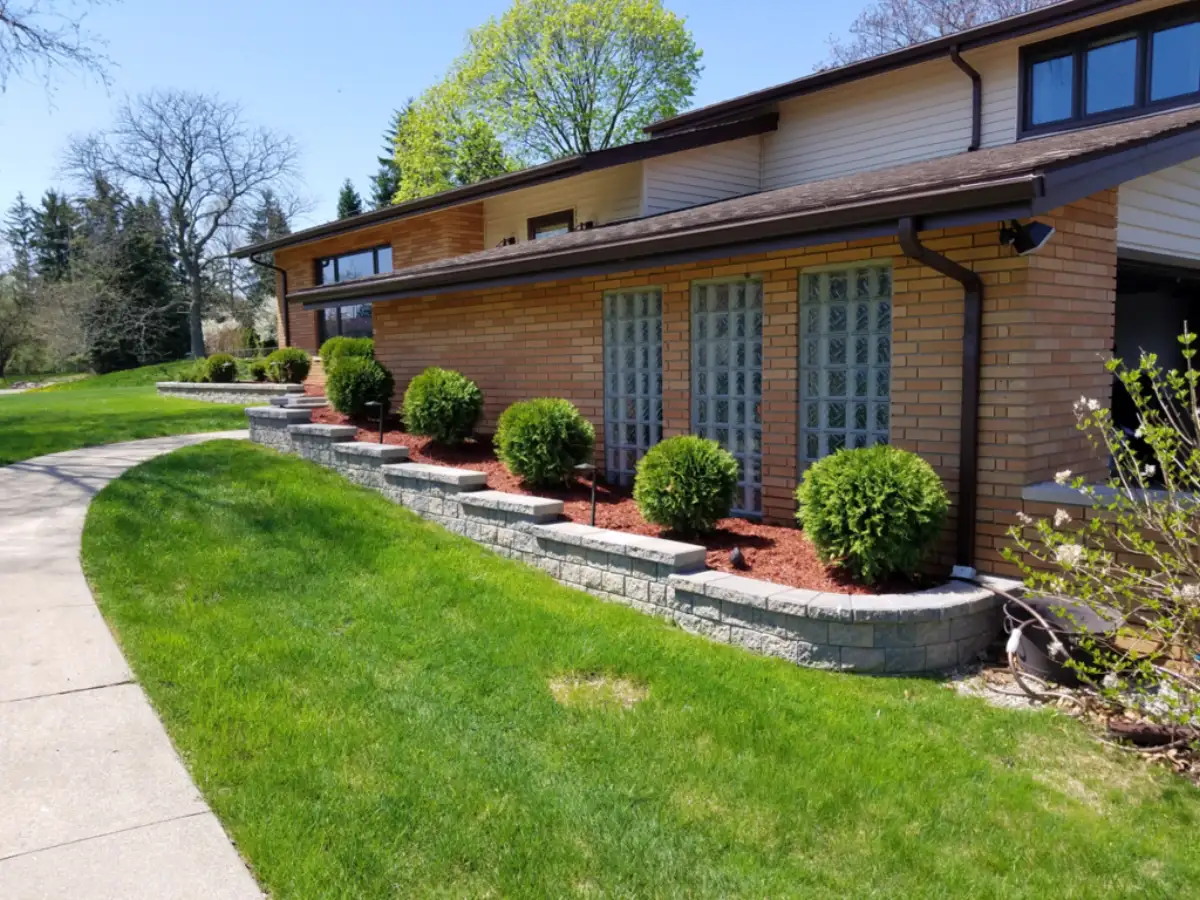 Multi-level paver patio with outdoor kitchen island and curved edges by The Guy Outdoor Services