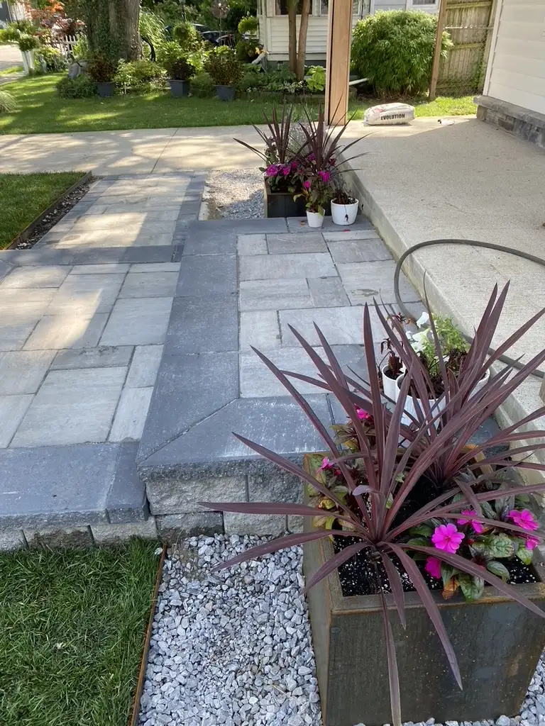 Decorative stone walkway and steps with colorful flower planters