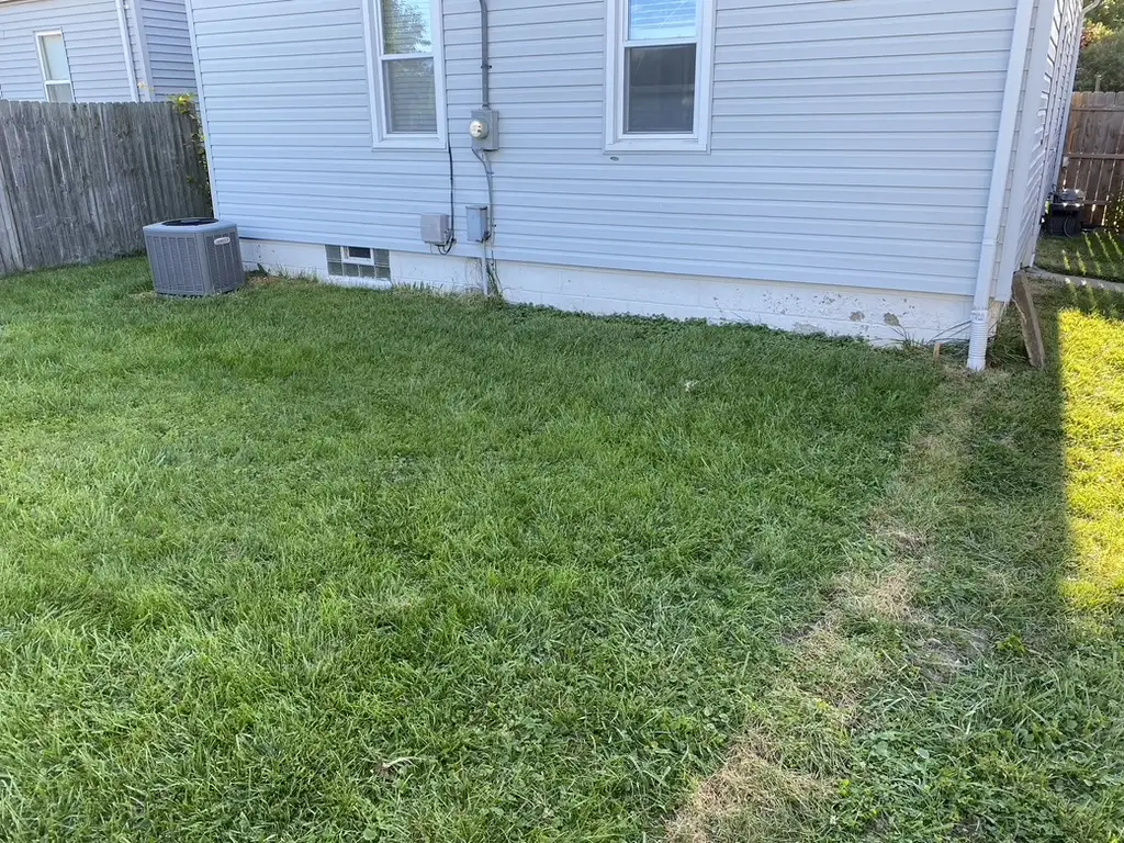 Finished paver walkway with decorative border and landscape beds