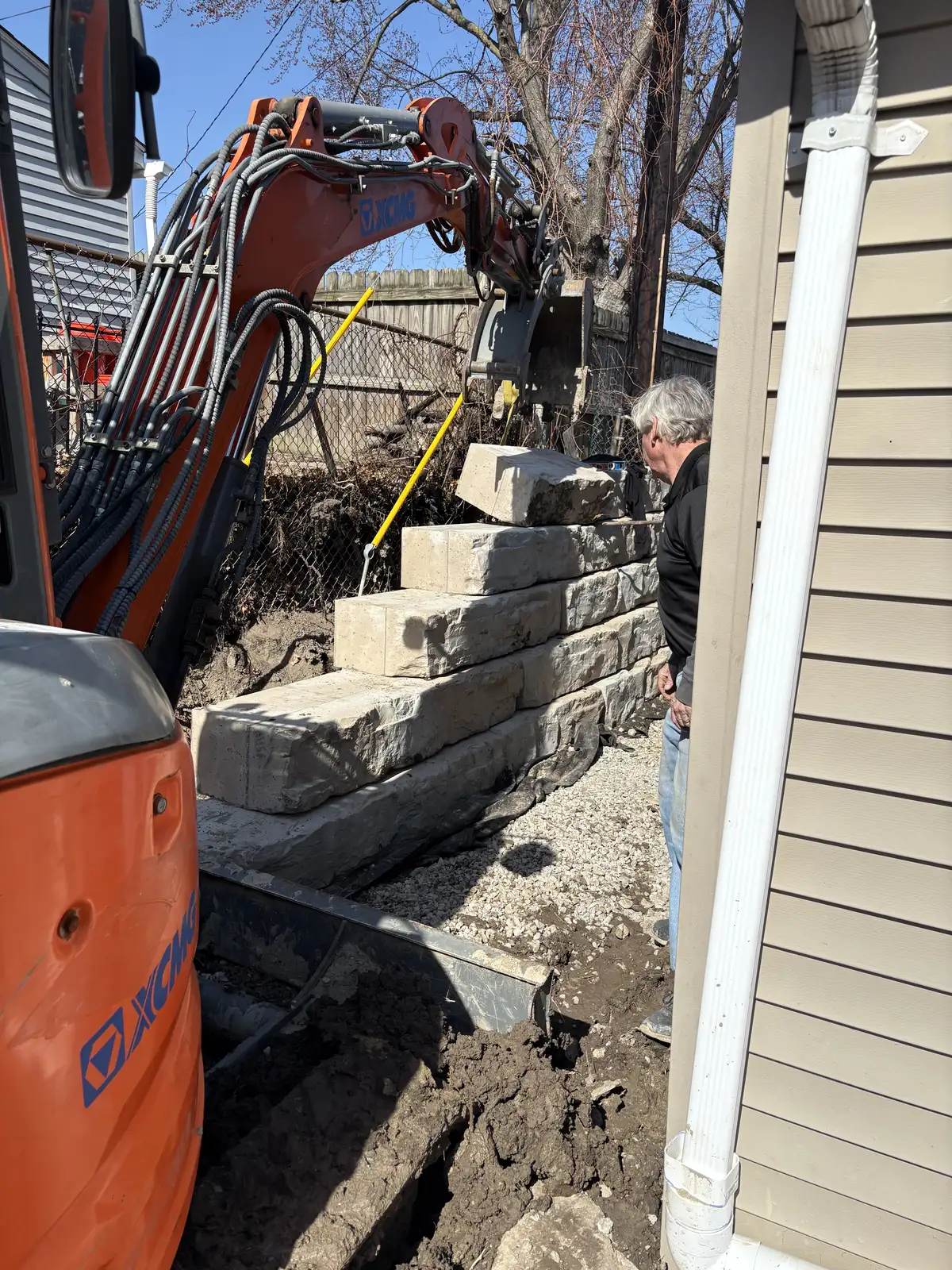 Retaining wall with integrated landscape design and grading