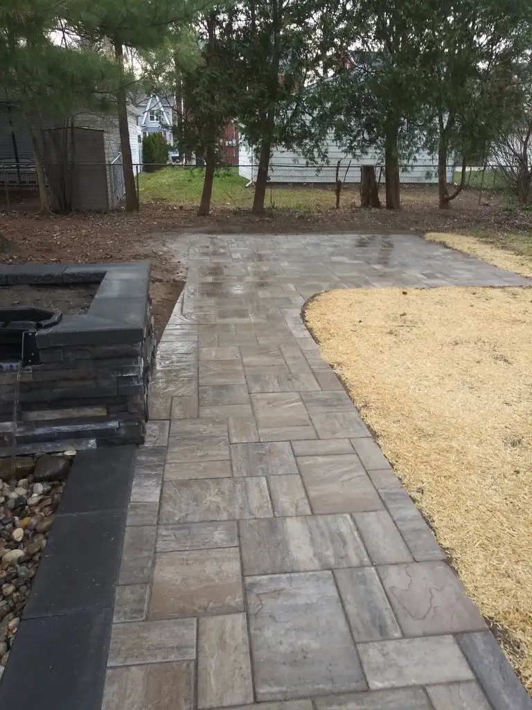 Naturalistic pond with waterfall and stone edging in Metro Detroit